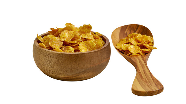 Golden crispy corn flakes in a round wooden bowl and a matching olive wood scoop
