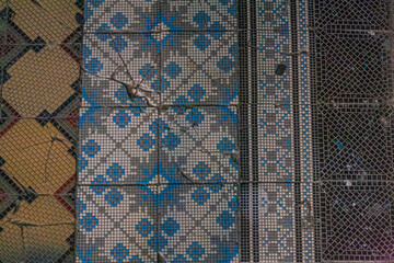 Vintage ceramic tile floor with blue mosaic ornament and geometric patterns