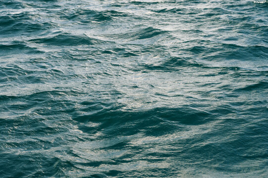 Deep Blue Sea Surface with Rolling Waves and Reflections