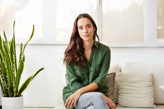 Woman, portrait and therapist with confidence on sofa for therapy or mental health rehab. Female person, psychologist or shrink with pride on couch for counseling or help in private practice