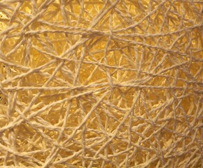 Yellow string thread nest texture background, intertwined paper yarn fiber pattern close-up