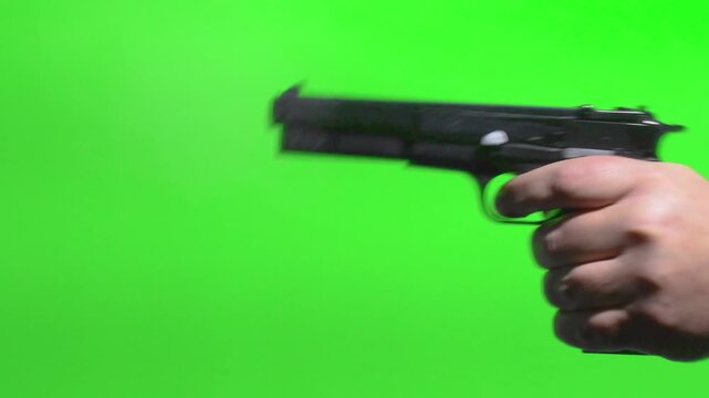 Gun shots on green screen close up with focus on action and hand movements chromakey