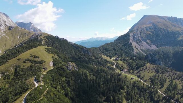 Aerial drone view from Jenner mountain near Sch&ouml;nau am K&ouml;nigssee, Germany, flying over scenic hiking trails, alpine meadows and forests surrounded by the majestic Berchtesgaden Alps