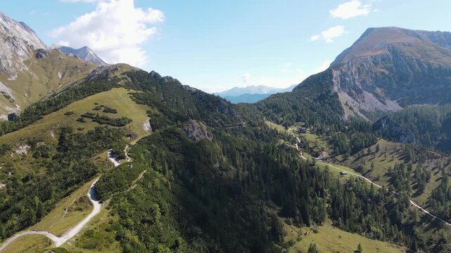 Aerial drone view from Jenner mountain near Sch&ouml;nau am K&ouml;nigssee, Germany, flying over scenic hiking trails, alpine meadows and forests surrounded by the majestic Berchtesgaden Alps
