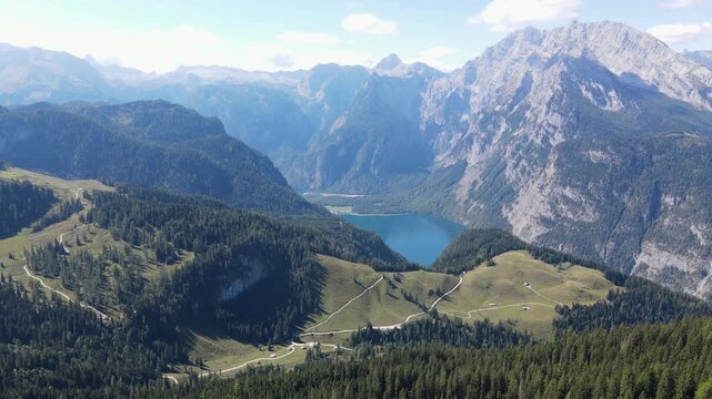 Aerial drone view of K&ouml;nigssee from Jenner mountain in Bavaria, Germany, flying toward the alpine lake surrounded by forests and dramatic peaks of the Berchtesgaden Alps