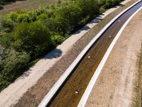Drone view shows river restoration activity focused on flood protection and management in a rural area.