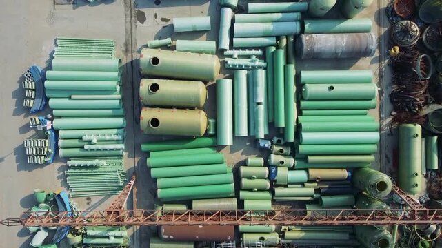 Aerial View of Industrial Storage Yard with Green Fiberglass Pipes and Tanks