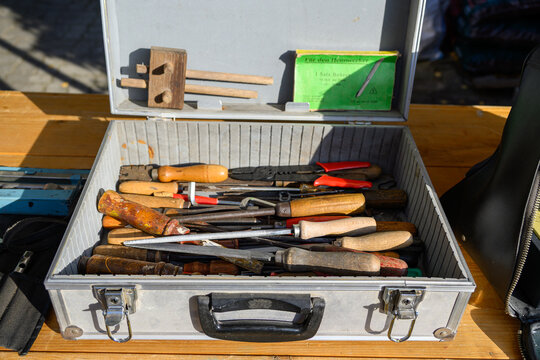 Toolbox with various tools shown clearly in the frame in an outdoor setting, in a clean visual environment, under daylight, with a natural mood, suitable for marketing, editorial.