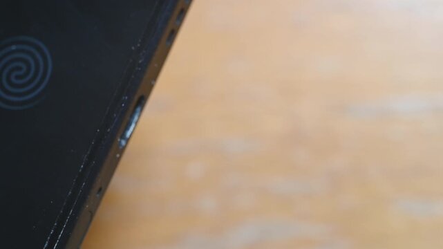 Close-up of USB-C cable plugging and unplugging into smartphone charging port