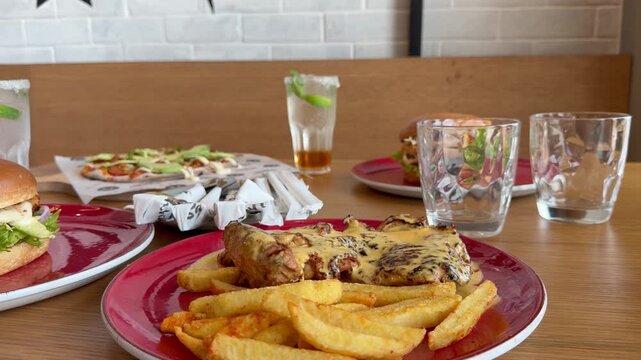 Lunch is served, peri peri chicken and chips with some other meals in the background.