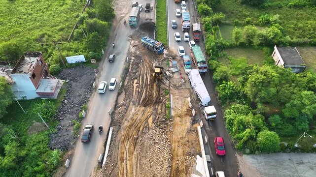 4K aerial showing active civil engineering roadworks and a logistics supply chain bottleneck on an Indian national highway.