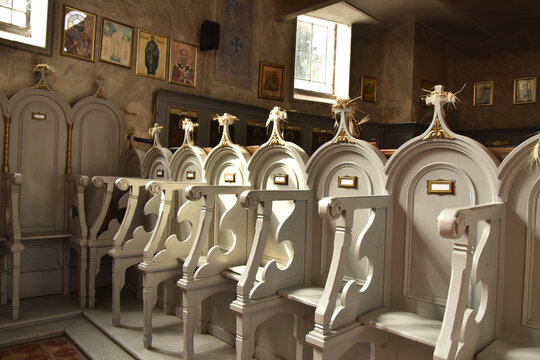 Church stalls with armrests and high backs called stasidia in Orthodox church