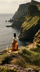 Obraz premium a serene coastal scene. A bottle of ambercolored whisky and a glass of the same whisky are placed on a rugged, grassy cliff overlooking the ocean. The cliff is covered in lush green vegetation.