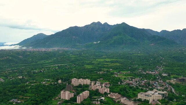 Aerial Hyperlapse of lush green Trikuta Hills in Katra highlighting Mata Vaishno Devi pilgrimage route.