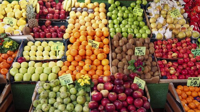 Vibrant and diverse produce market stall with fresh fruits and vegetables on display, capturing a lively and colorful scene