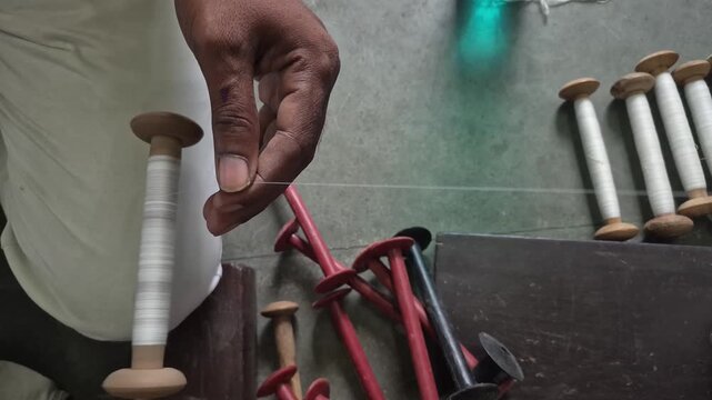 Handloom weaver preparing yarns in India.