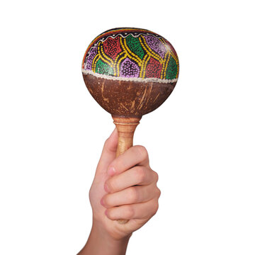 Woman holding colorful maraca isolated on transparent background. Traditional wooden percussion instrument from Latin America. Folk music rhythm accessory for festival and celebration performance.