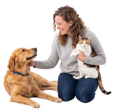 smiling woman petting a golden dog while holding a cat