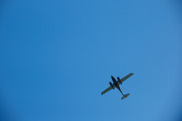 Fototapeta premium Twin-Engine Turboprop Airplane Flying in Clear Blue Sky