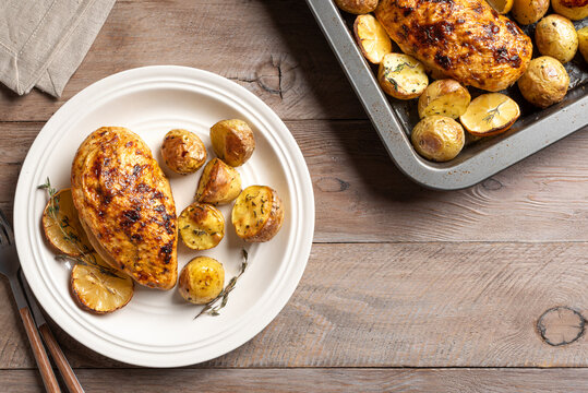 Oven roasted lemon garlic chicken and baby potatoes on plate