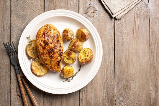 Oven roasted lemon garlic chicken and potatoes on plate
