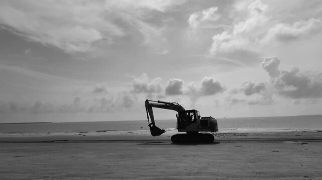 Excavator at a beach to protect sea wall.