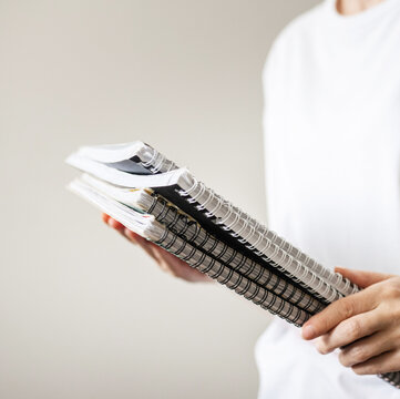 Person holding notebooks and folders, person holding notebooks and folders, notebook theme, study theme, lifestyle theme