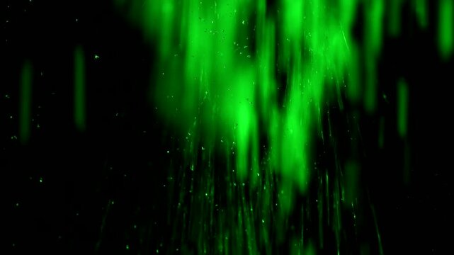 Tiny snow or dust randomly flying in the smoky air, empty space template for objects advertisement. Many dust particles cloud of white powder in green light on empty dark black contrast background.
