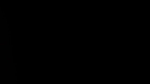 Wet snow and streams of water flow onto the black isolated background of the studio in dim lighting, an empty template for advertising objects.