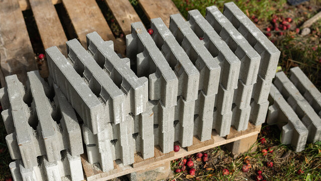 Stack of Gray Interlocking Concrete Paving Blocks on Wooden Pallet 
