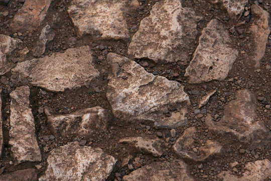 limestone rock fragments soil texture background gray beige rough surface natural terrain closeup pattern concept of nature, geology, background