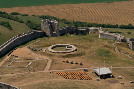 spis castle aerial view stone walls tower courtyard cannons wooden benches farmland slovakia medieval fortress ruins historic landmark concept of travel, history, tourism
