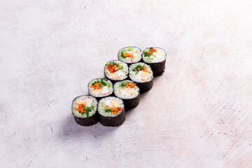 Eight sushi rolls with vegetables and egg on textured surface food © Игорь Соколов
