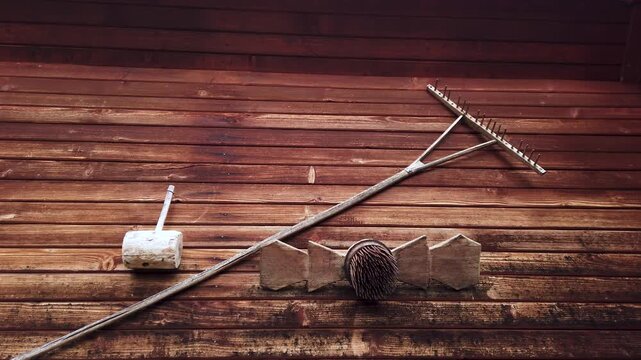 Still video of antique tools hanged on wooden wall background 