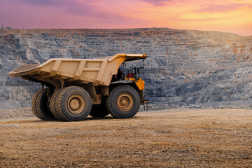 Rear view of articulated dump truck on quarry plateau at dusk © Parilov