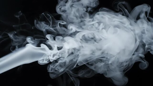 White smoke or ink swirling and dissolving in water against a deep black background.