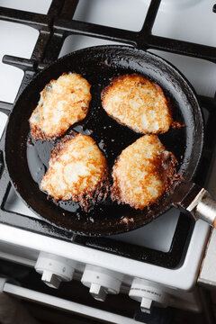 Traditional potato pancakes (Draniki) fried in cast iron skillet