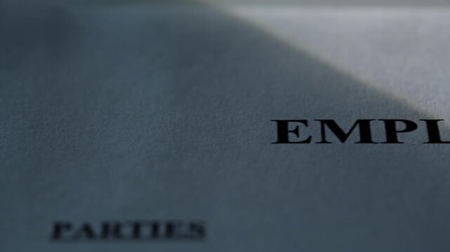 closeup employment contract agreement document detailed paper placed on flat surface