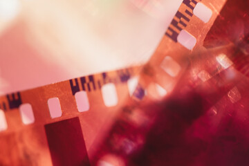 Vintage analog photo film stripes with light leaks and bright lens flare, scratch distressed texture with soft colorful glow, retro cinematic abstract  photography overlay background. © juliasudnitskaya