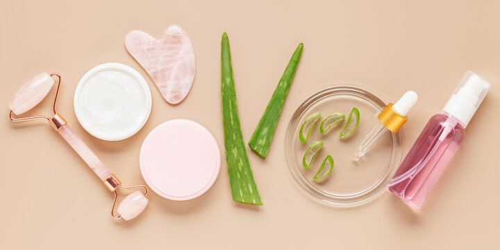Aloe leaf, juice and jade face roller. Cosmetics concept. Natural eco organic cosmetics. Top view