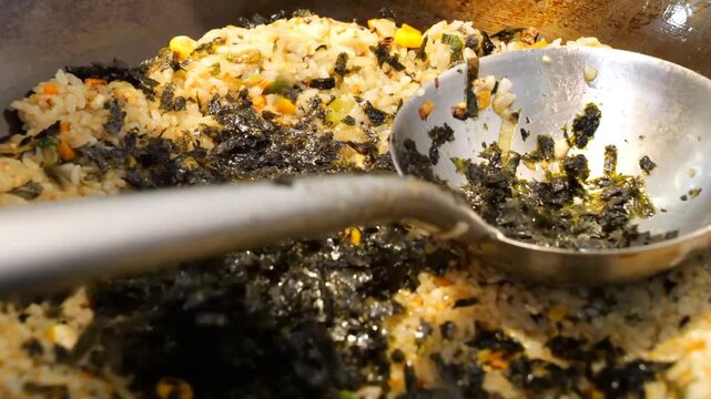 Detailed sequence showing seasoned white rice tossed with vegetables and seaweed, then transferred and arranged inside a crab shell plate for gourmet presentation