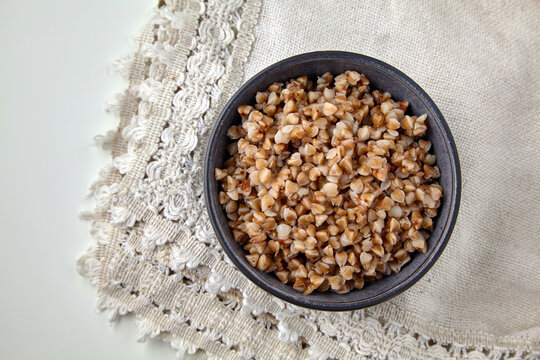 Cooked Buckwheat Porridge in Bowl on Rustic Linen Napkin