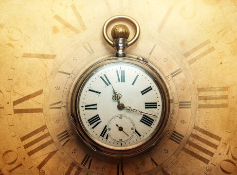 The old antique classic clocks on a vintage wide paper background. Concept of time, history, science, memory, information. Retro style. Vintage clockwork aand watch background.
