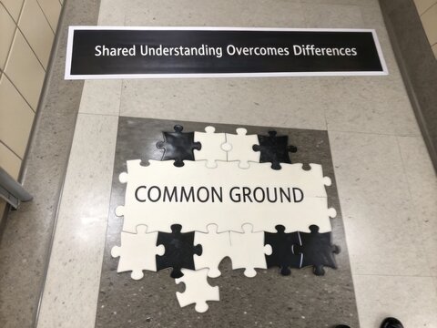 Puzzle Pieces Forming "Common Ground" With Overhead Message