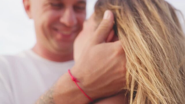 Man gently stroking woman&rsquo;s hair in close-up moment of comfort and emotional support, expressing care, trust, compassion and strong connection between loving partners