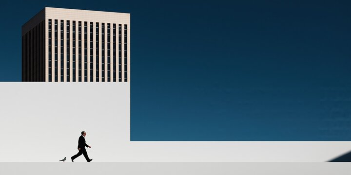 Lone businessman in a suit walks purposefully past a modern office building against a clear blue sky