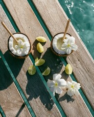 Fototapeta premium Tropical coconut drinks with flowers on wooden pier above blue ocean