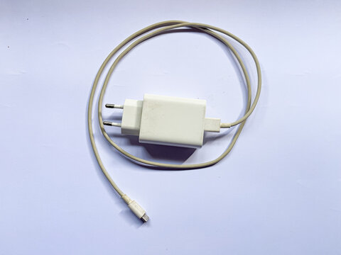 USB wall charger with charging cable for powering mobile devices, useful for technology, smartphone accessories, electronics, charging, connectivity, and everyday device use.