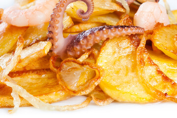 Fried potatoes with octopus shrimp mussels and onion over potato © besjunior