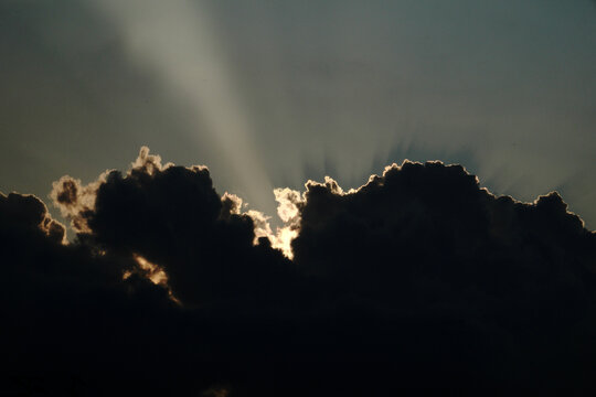   
Sunbeams Breaking Through Storm Clouds